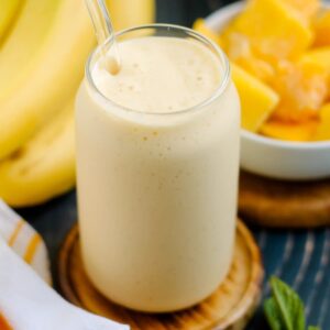 A glass of mango banana smoothie.