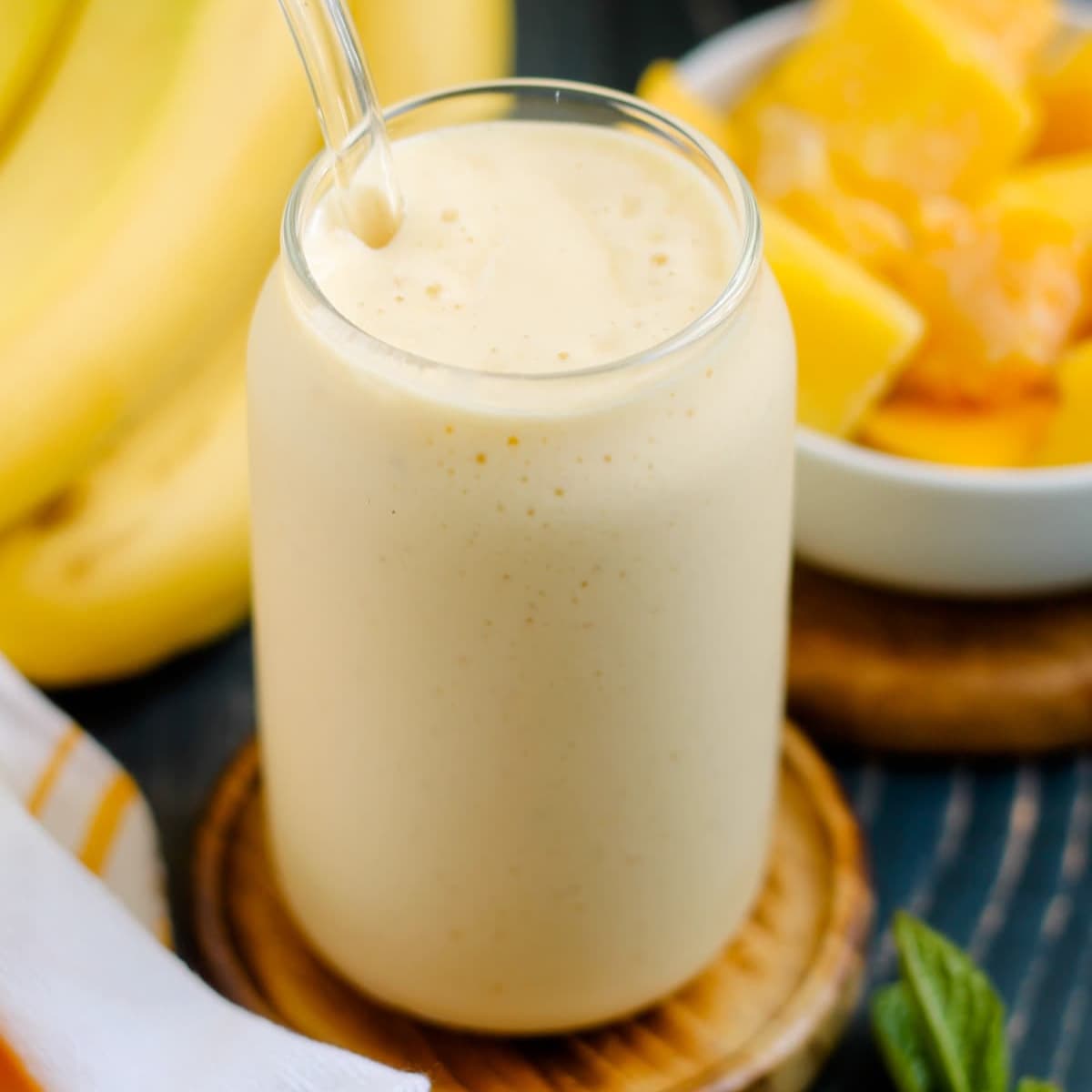 A glass of mango banana smoothie.