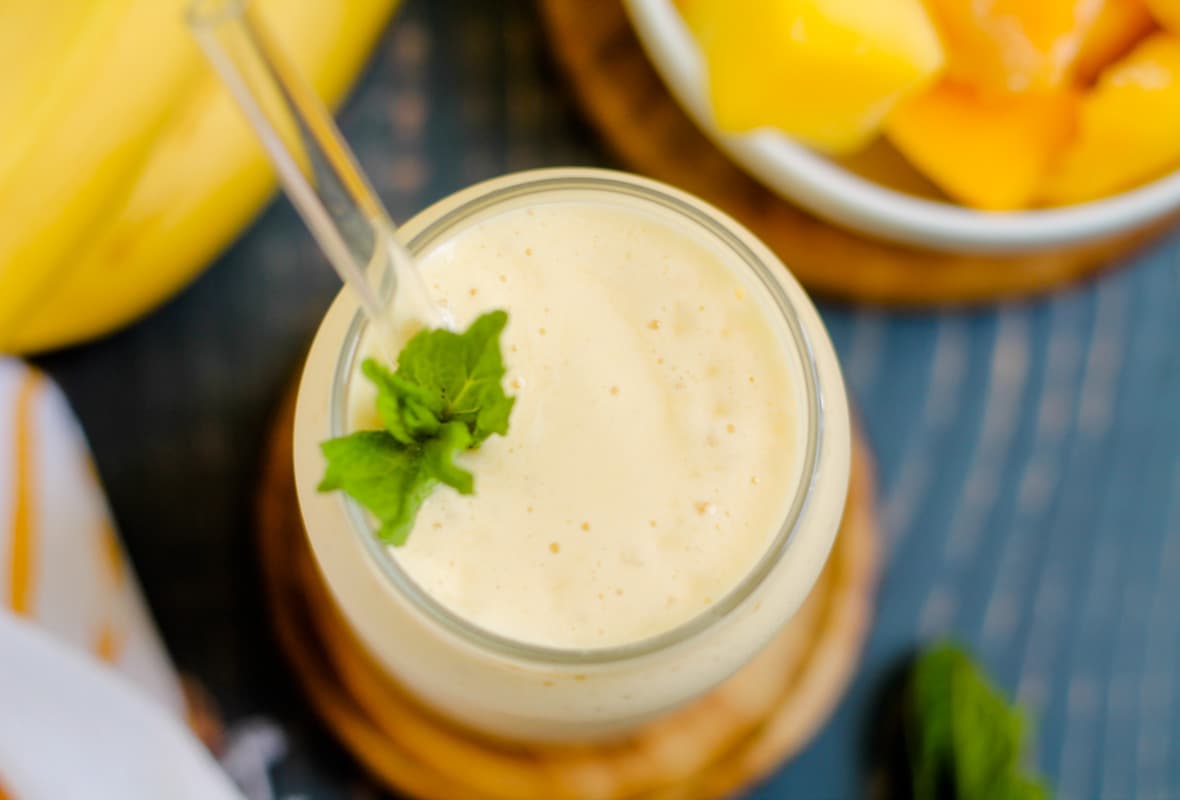 A glass of mango banana smoothie.