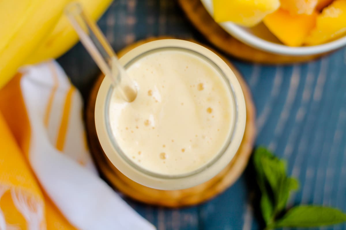 A glass of mango banana smoothie.