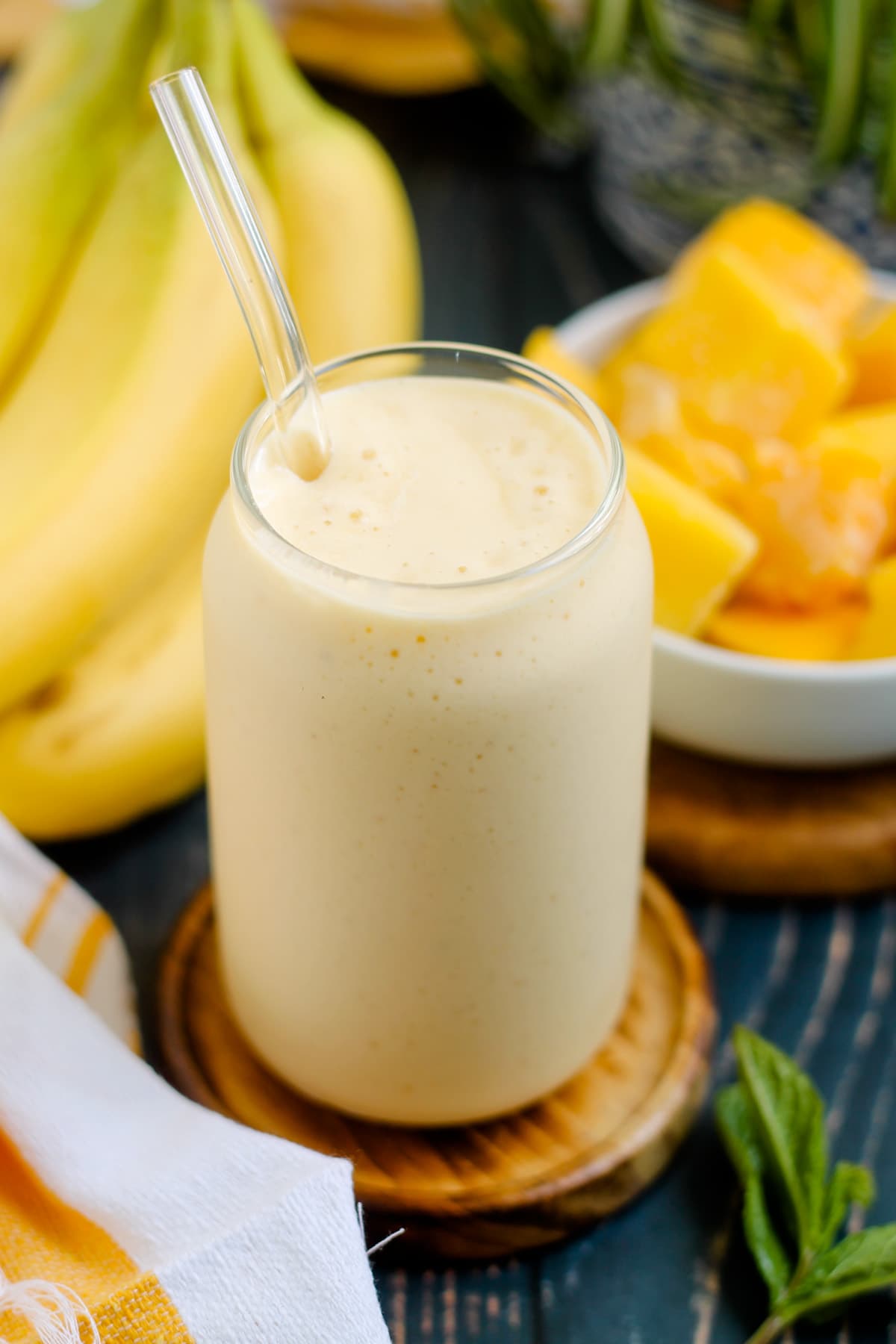 A glass of mango banana smoothie.