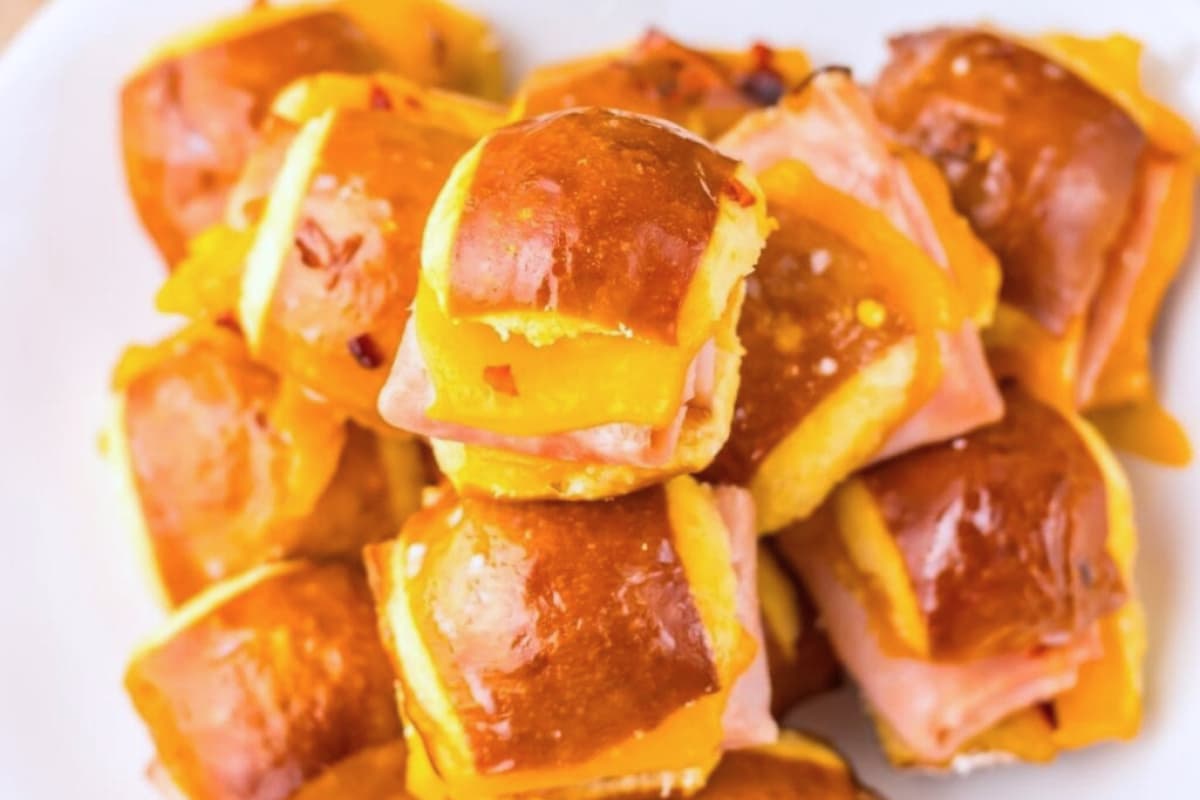 A plate of Mini Ham and Cheese Pretzel Bites with Hot Honey.