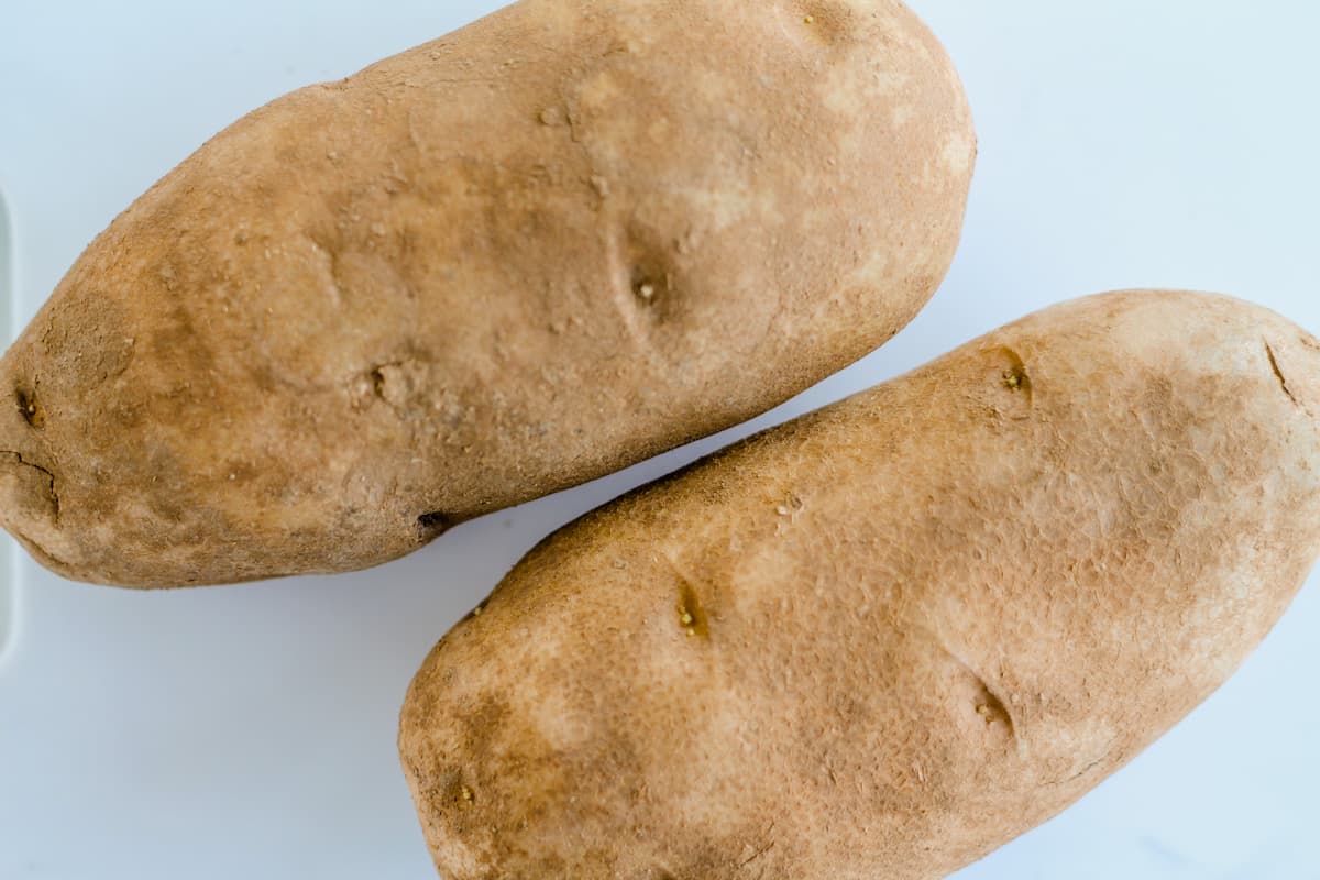 Russet potatoes on a counter.