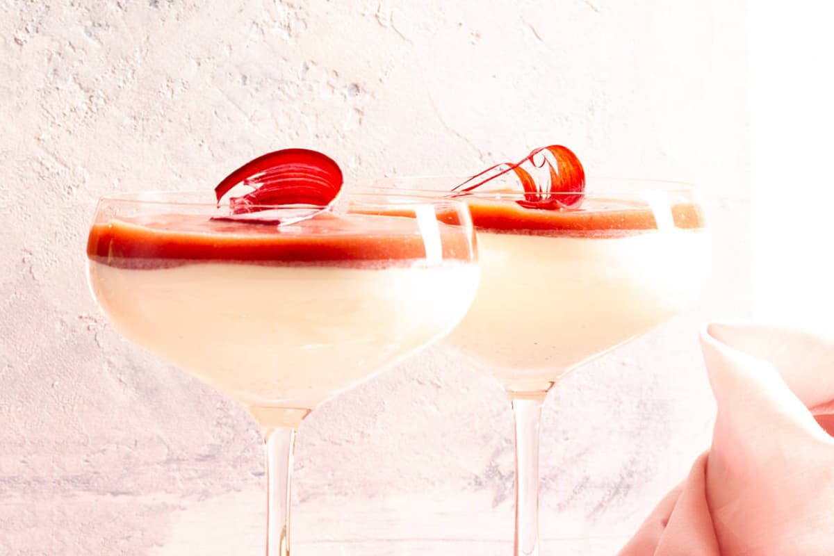 Glasses of Vanilla Panna Cotta with Rhubarb Coulis.