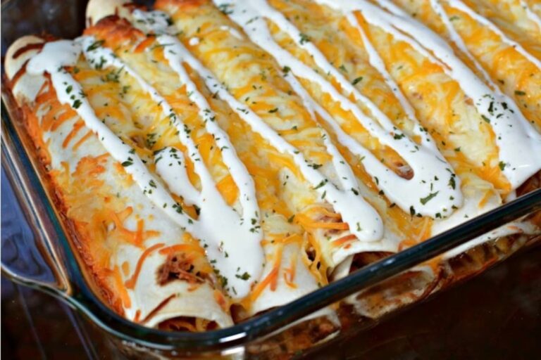A dish of Slow Cooker Ranch Chicken Enchiladas.