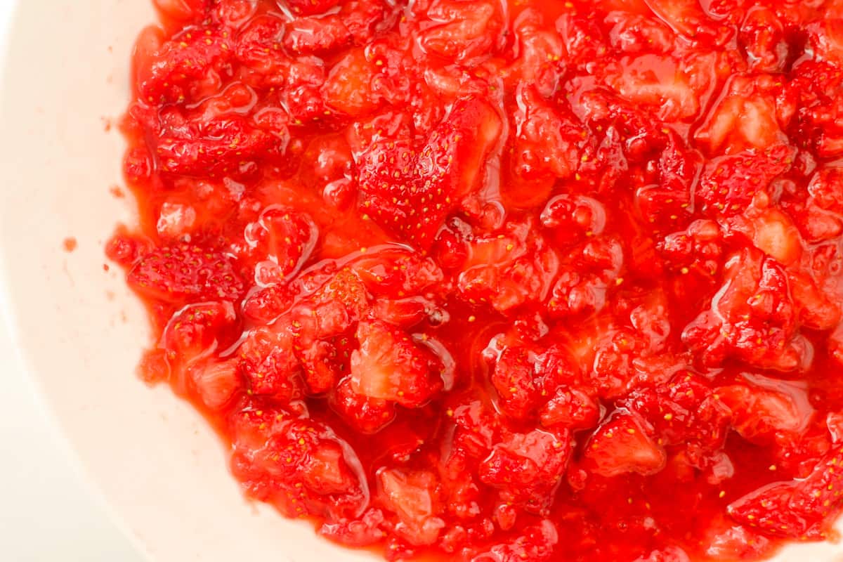 A bowl of mashed strawberries.