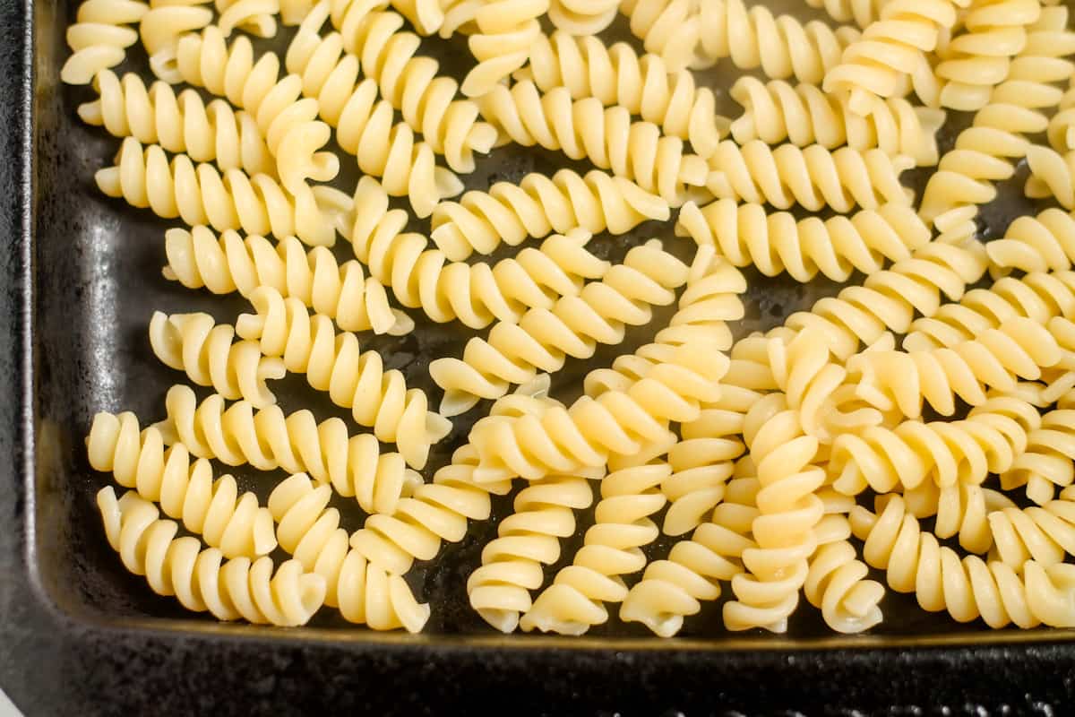 Rotini on a baking sheet.