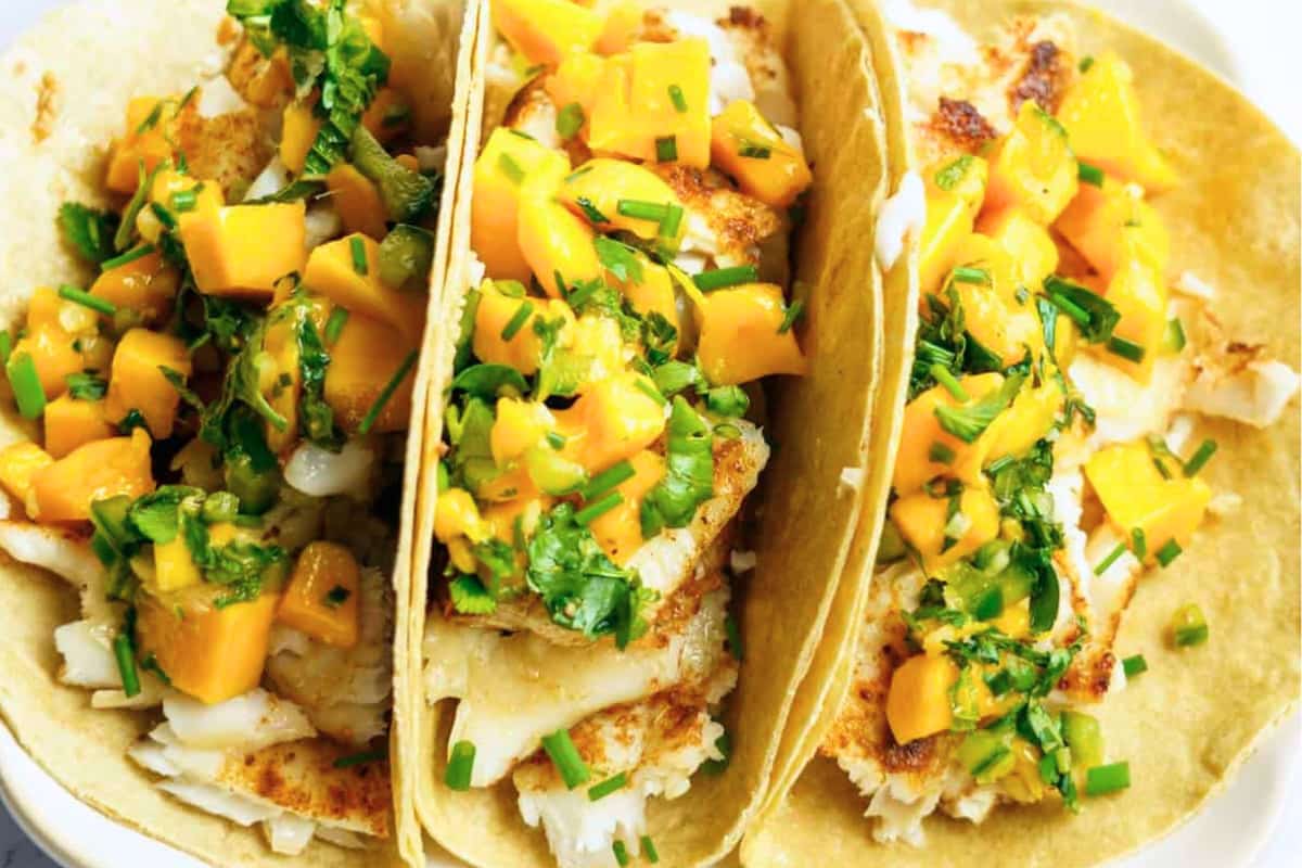 A plate of Fish Tacos with Mango Mint Cilantro Salsa.