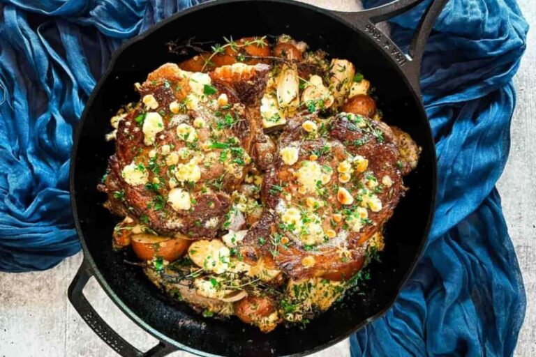A pan of Cast Iron Ribeye Steak with Pears and Blue Cheese.