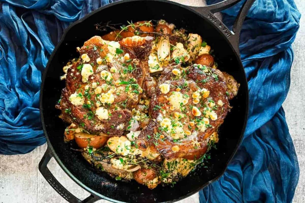 A pan of Cast Iron Ribeye Steak with Pears and Blue Cheese.