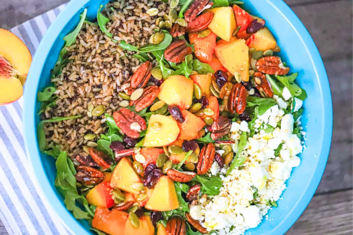 A dish of Peach Quinoa Brown Rice Arugula Salad.