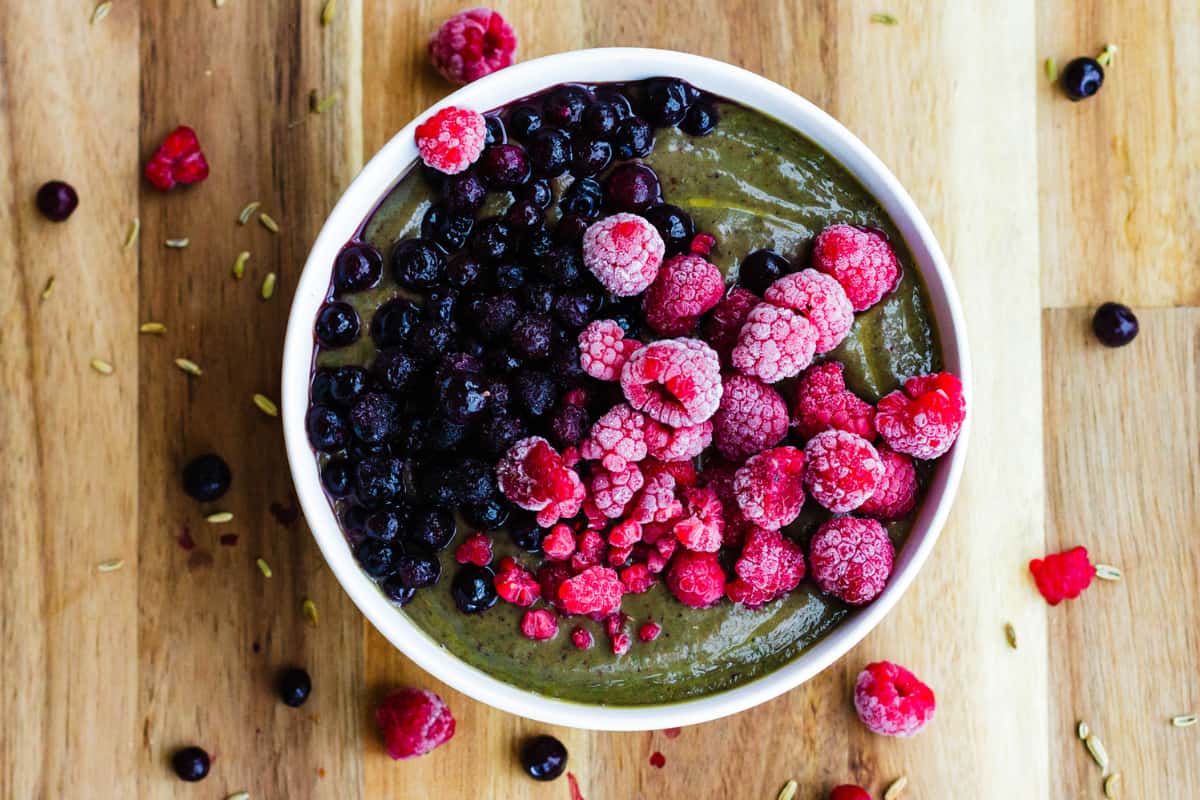 A dish of Avocado Spinach Green Smoothie Bowl.