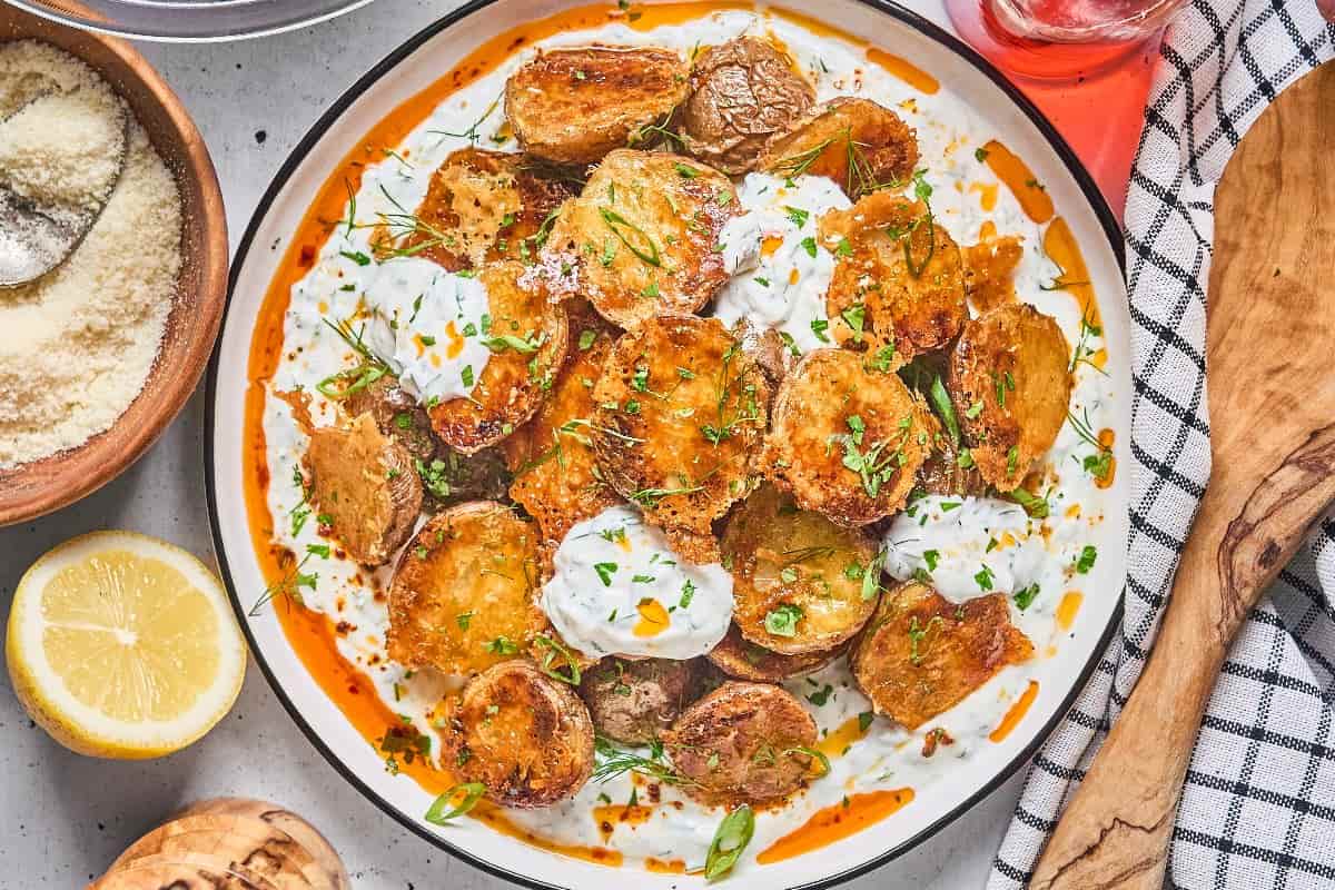 A plate of Crispy Parmesan Potatoes with Fresh Herbs.