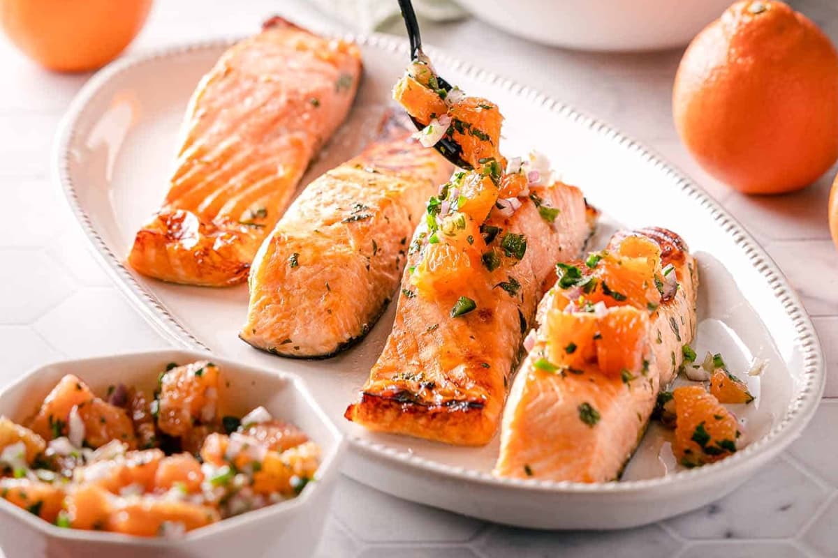 A plate of Citrus Herb Salmon with Orange Red Onion Salsa.