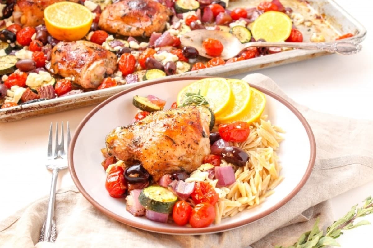 A dish of Sheet Pan Mediterranean Chicken Thighs.