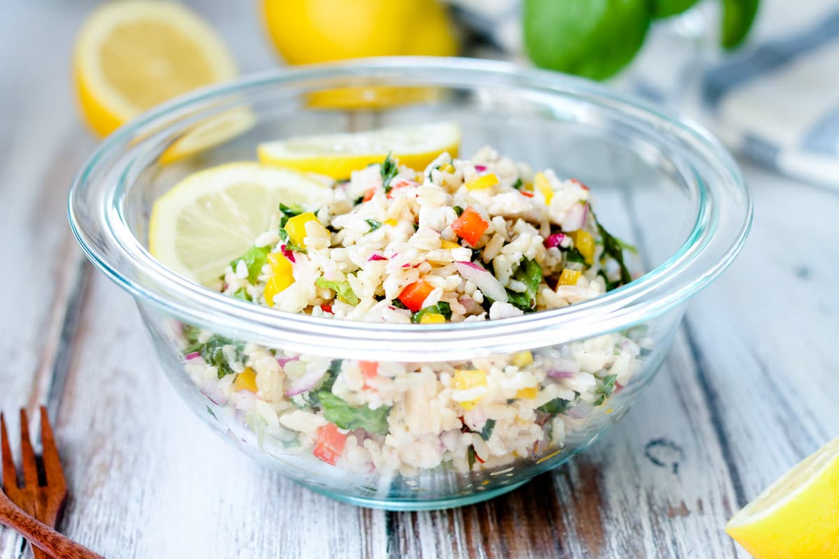 A bowl of chicken rice salad.