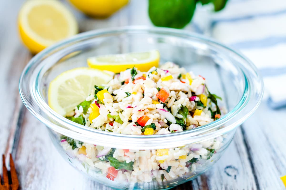 A bowl of chicken rice salad.