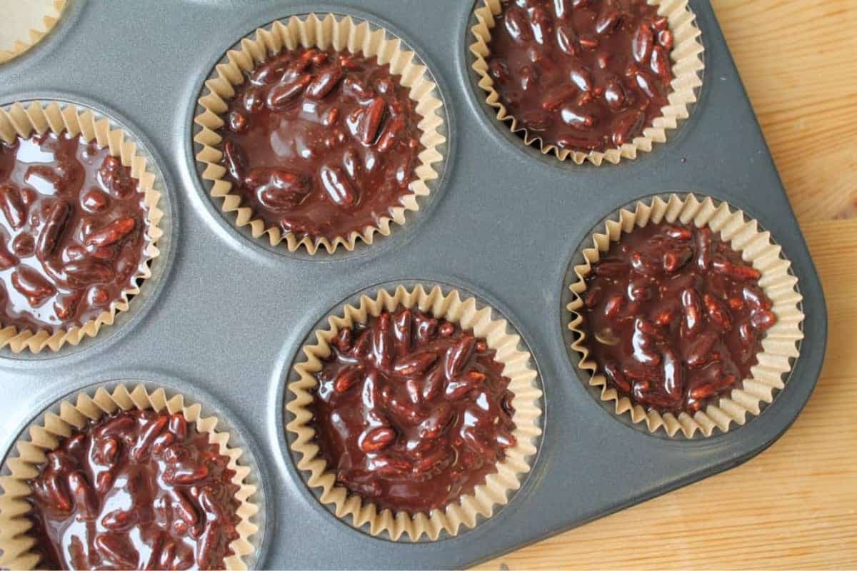 Chocolate mixture in a muffin tin.