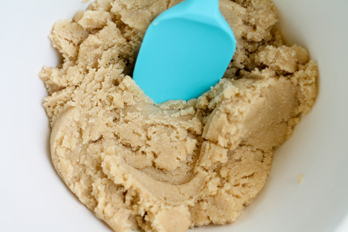 A bowl of dough being stirred.
