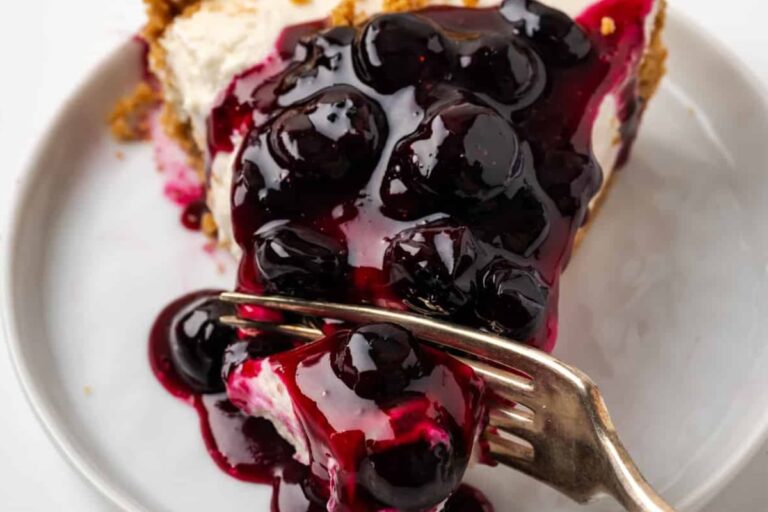 A plate of gluten free blueberry cheesecake.