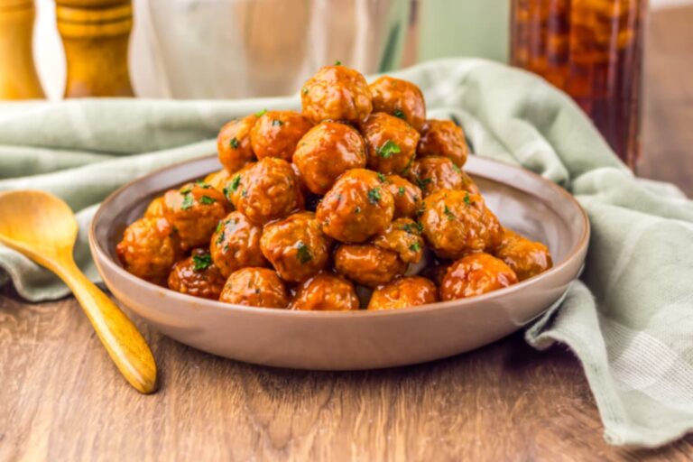 A dish of Saucy Crockpot Honey Bourbon BBQ Meatballs.