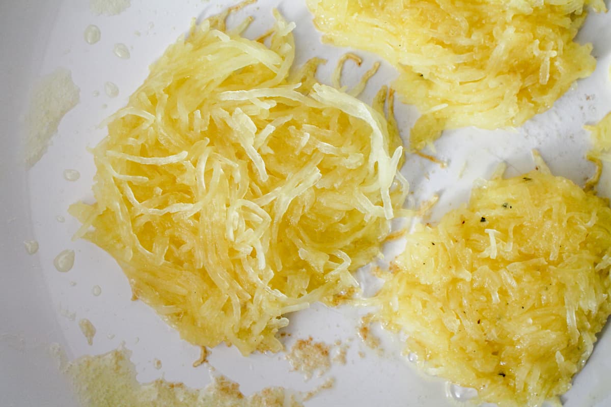 A pan with spaghetti squash hash browns cooking.