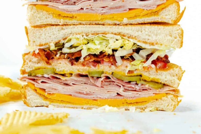 A plate of Classic Clubhouse Sandwich.