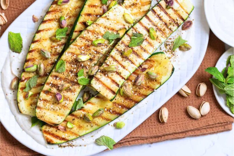 A dish of Grilled Zucchini with Tahini Yogurt Sauce.