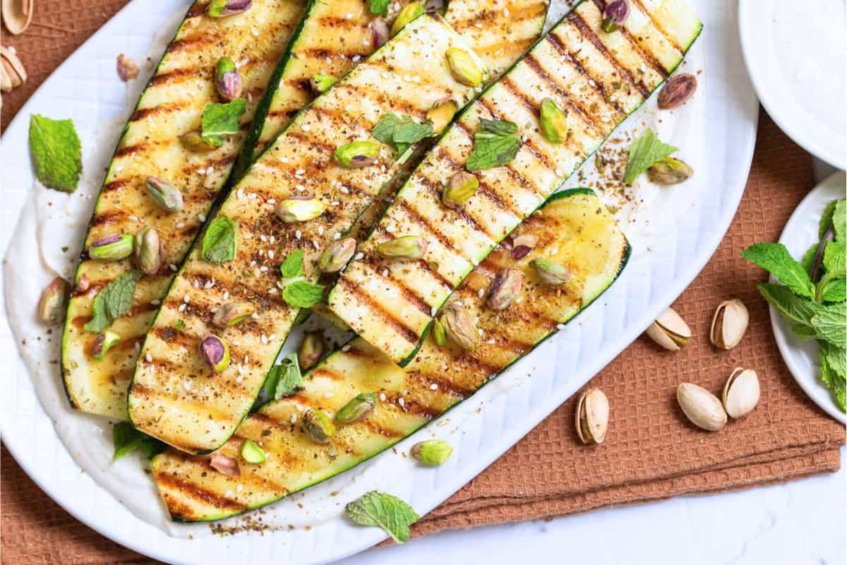 A dish of Grilled Zucchini with Tahini Yogurt Sauce.