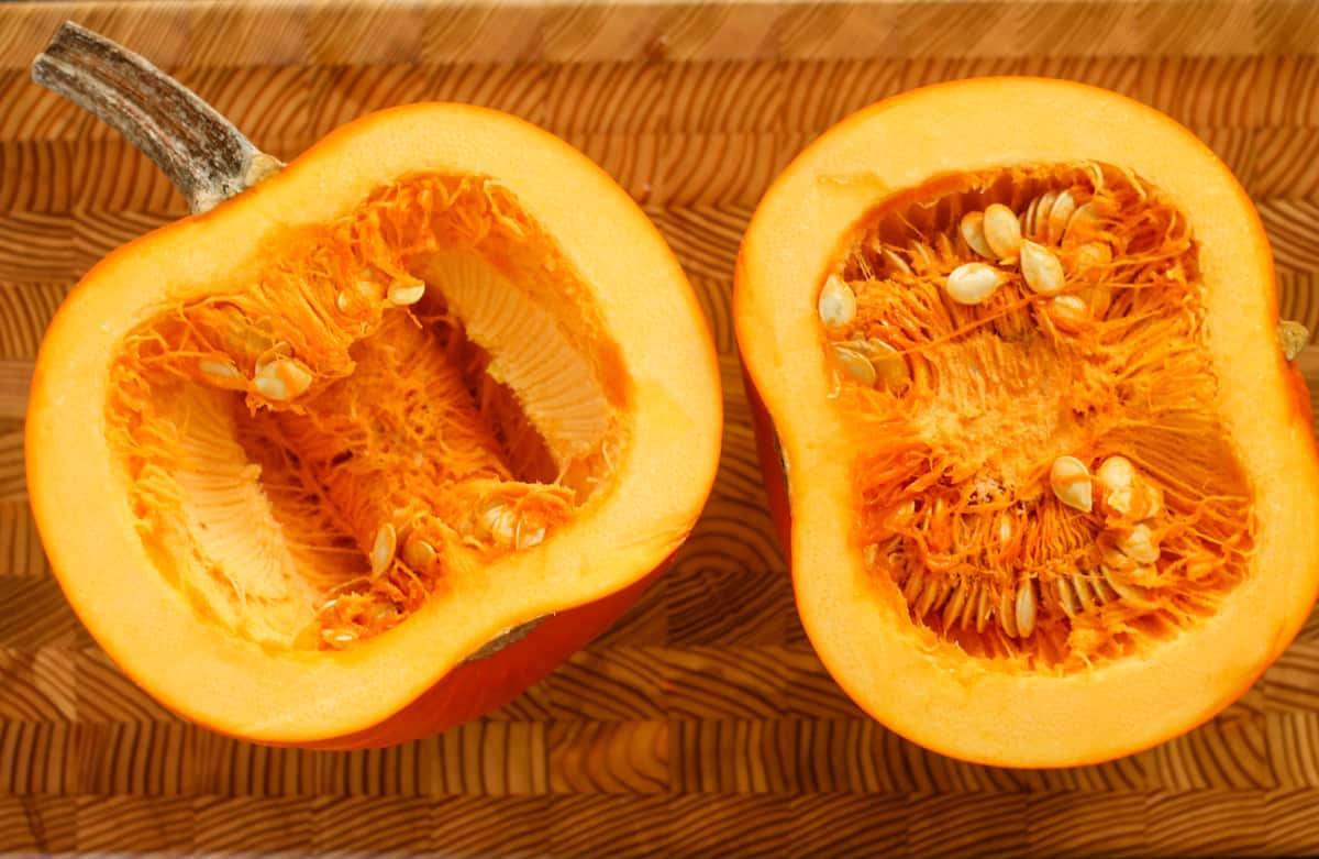 A sugar pumpkin sliced in half.