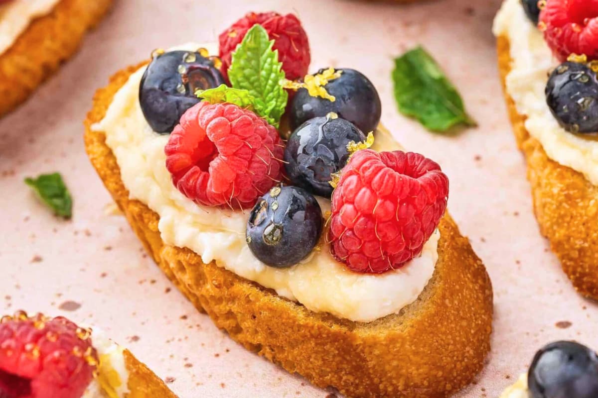 A plate of Whipped Ricotta Crostini with Berries.