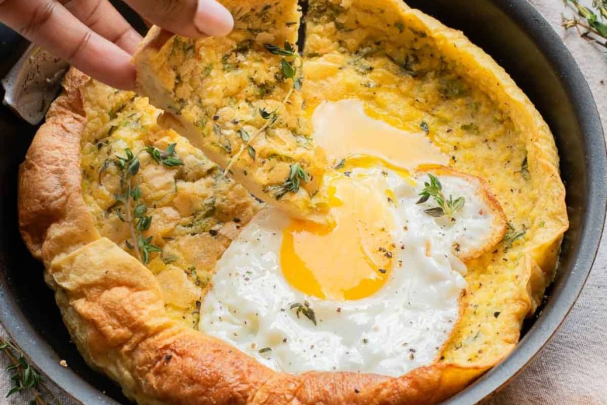 A dish of Savory Dutch Baby with Fresh Herbs and Fried Egg.