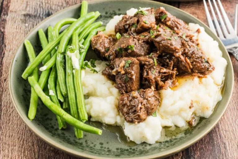 A dish Slow Cooker Garlic Steak Bites.