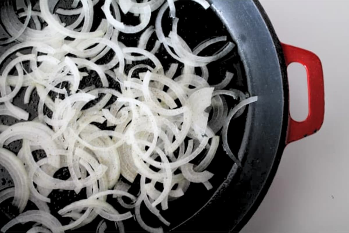 A skillet of onions cooking.