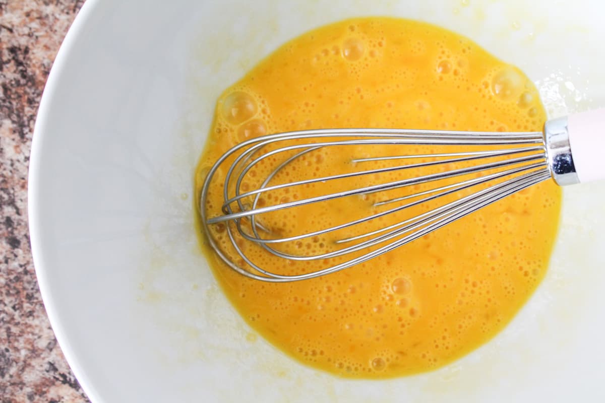 Eggs being beaten in a bowl.