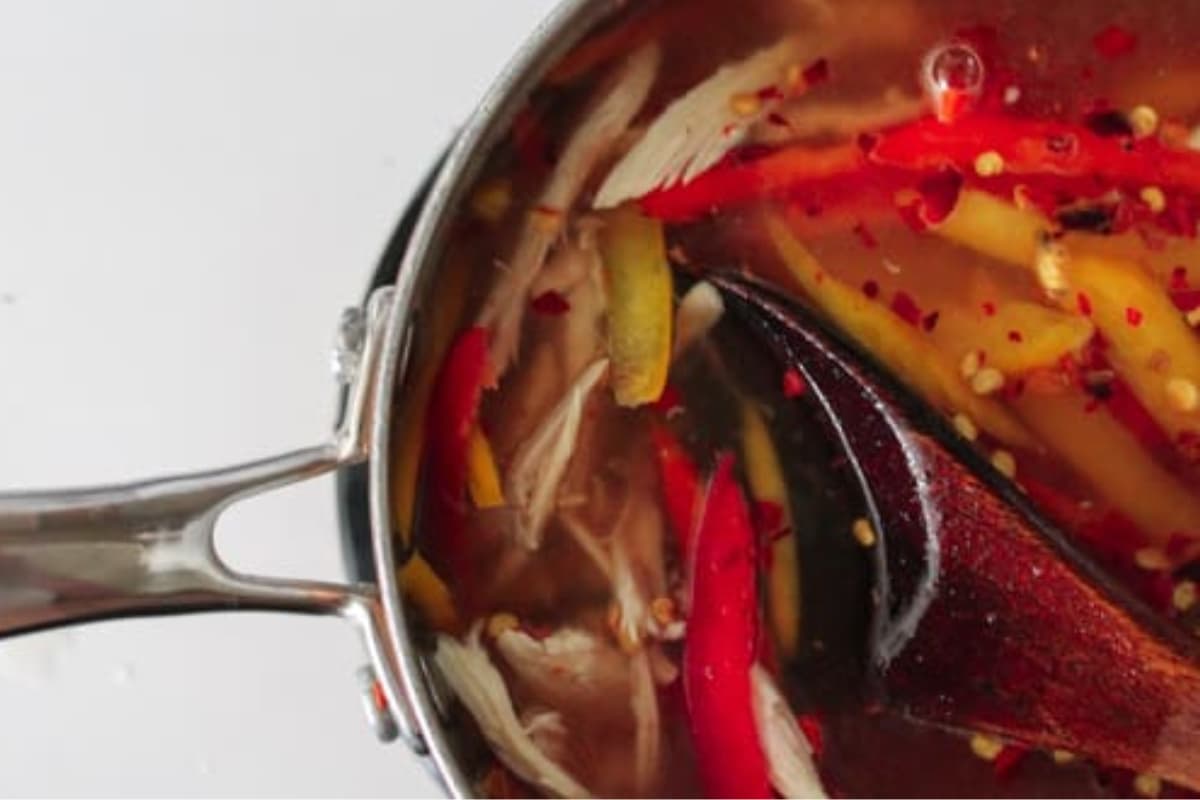 A spoon stirring soup.