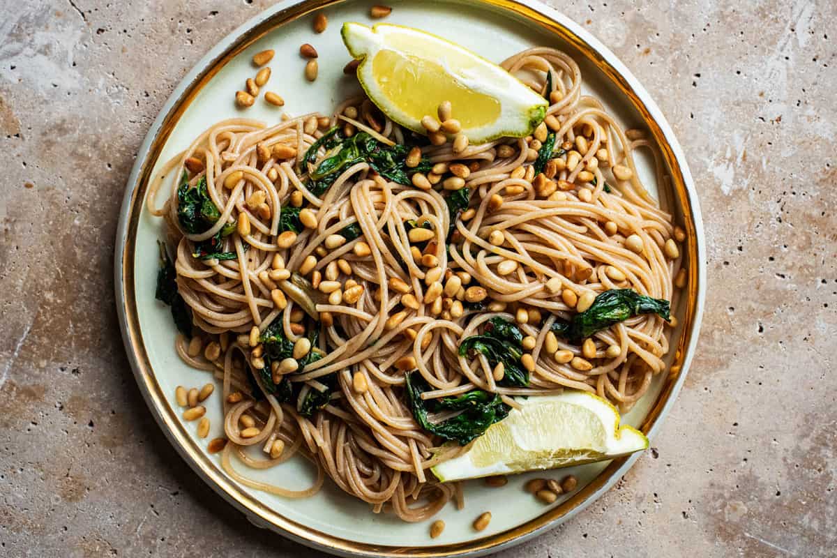 A dish of Garlic Spinach Pasta with Pine Nuts.