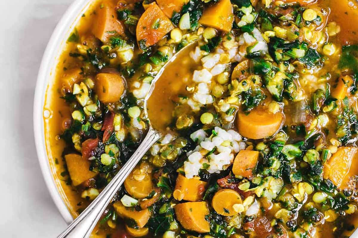 A dish of Carrot, Red Lentil, and Spinach Soup.