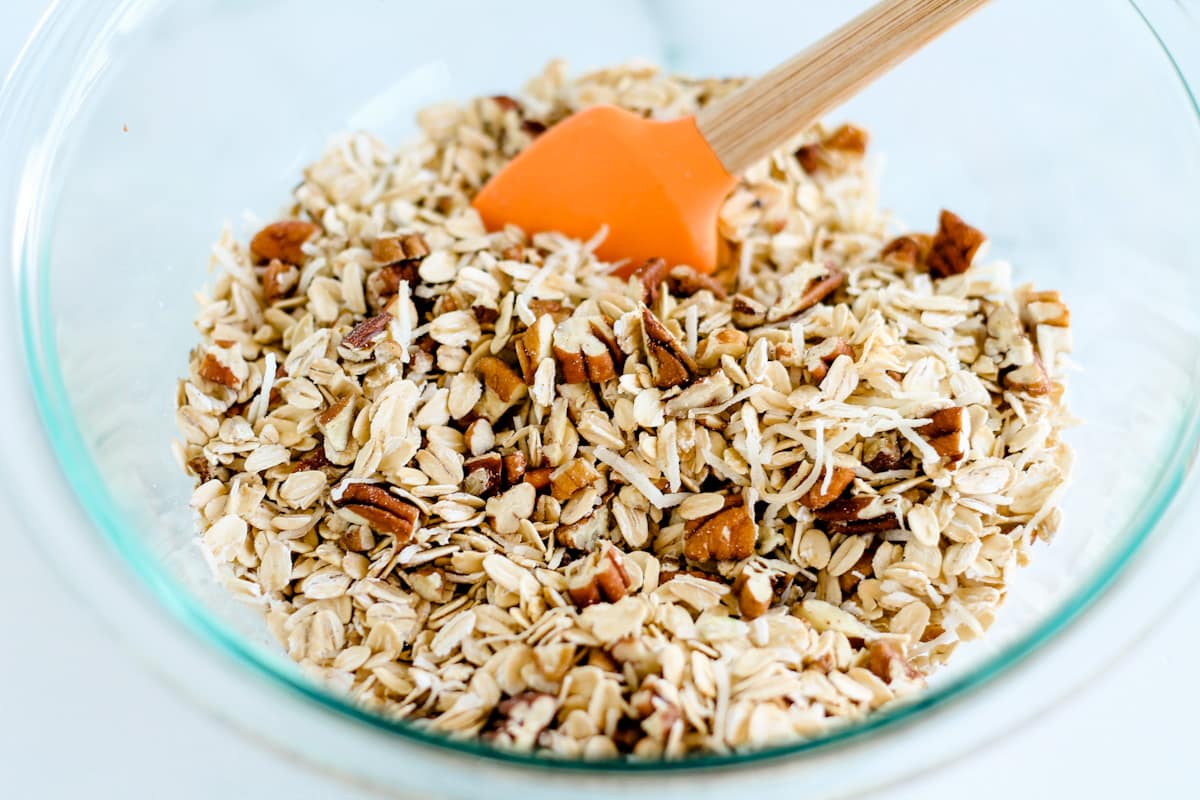 Oats, coconut, and pecans in a bowl.