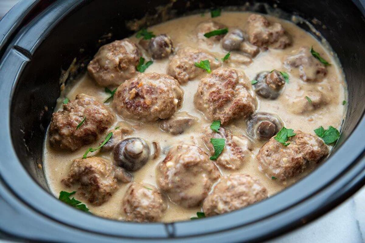 A dish of Crock Pot Meatballs with Creamy Mushroom Gravy.