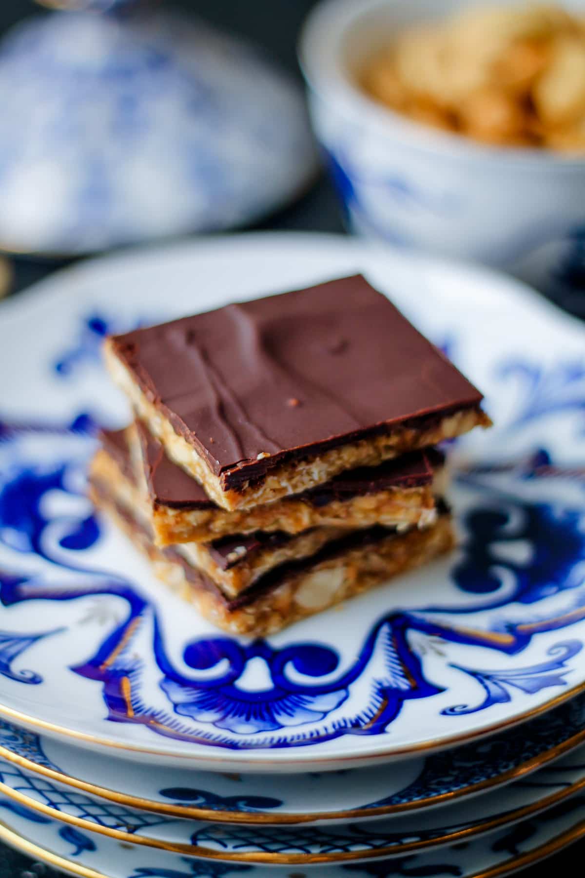 Stack of toasted cashew candy bars showing the oat and peanut butter base.