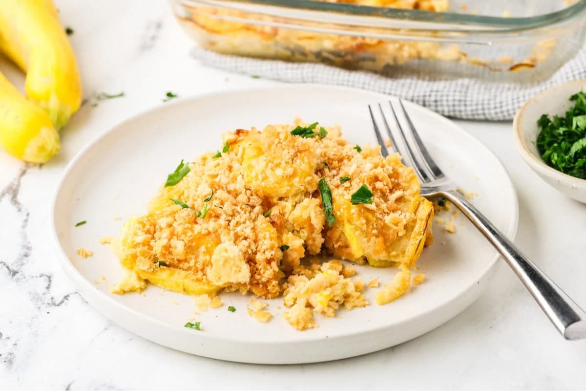 A dish of Squash Casserole with Ritz Cracker Topping.
